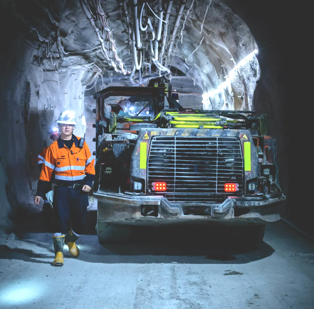 An operator beside an underground loader