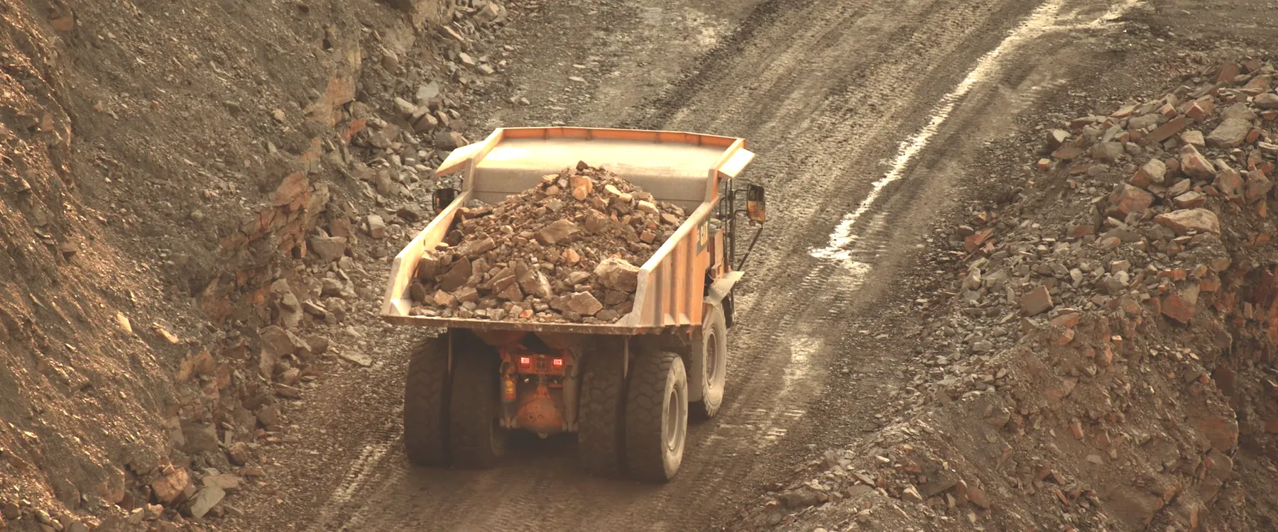 A loaded haul truck climbing out of a pit