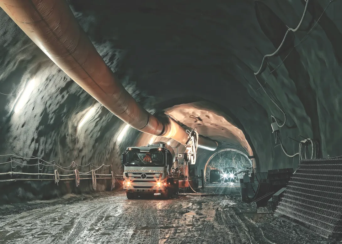 A vehicle in a lit underground haulage tunnel